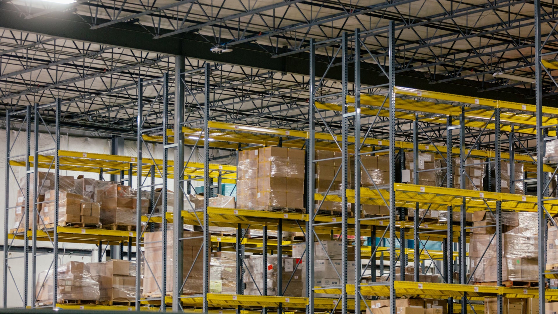 Interior of a warehouse with shelves and stacked boxes